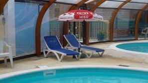 Indoor pool, seasonal outdoor pool, pool umbrellas, pool loungers