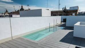 Seasonal outdoor pool, open 11:00 AM to 8:00 PM, pool umbrellas
