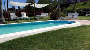 Seasonal outdoor pool, open 10:00 AM to 8:00 PM, pool umbrellas