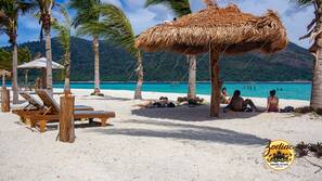 On the beach, white sand, beach umbrellas, beach towels