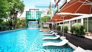 Outdoor pool, open 6:00 AM to 10:00 PM, pool loungers