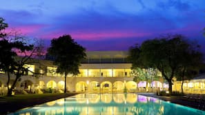 Outdoor pool, open 10:00 AM to 5:00 PM, pool umbrellas