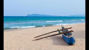 On the beach, white sand, beach umbrellas, beach towels