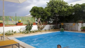Seasonal outdoor pool, open 10:30 AM to 8:00 PM, pool umbrellas