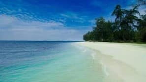 On the beach, white sand, sun-loungers, beach umbrellas