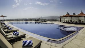 Outdoor pool, open 7 AM to 9:00 PM, pool umbrellas
