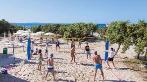 On the beach, sun loungers, beach umbrellas, windsurfing