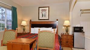 Desk, iron/ironing board, bed sheets