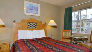 Desk, iron/ironing board, bed sheets