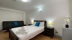 Premium bedding, laptop workspace, blackout curtains, iron/ironing board