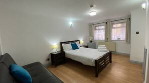Premium bedding, laptop workspace, blackout curtains, iron/ironing board
