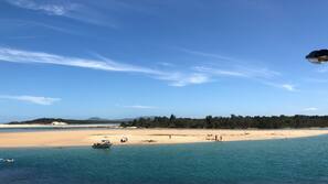 Beach nearby, white sand, beach umbrellas, kayaking
