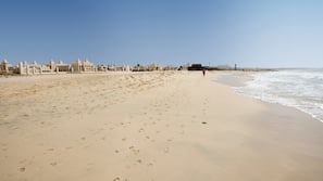 Perto da praia, espreguiçadeiras, guarda-sóis