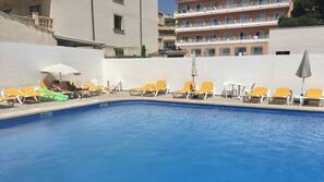 Seasonal outdoor pool, pool umbrellas, pool loungers