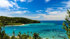 On the beach, white sand, sun-loungers, beach towels