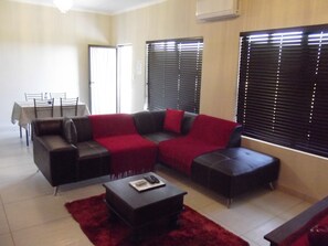 Deluxe Apartment, 2 Bedrooms | Living room | TV