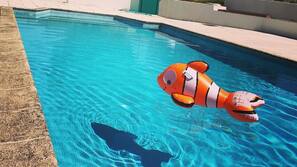 Seasonal outdoor pool, open 9:00 AM to 8:00 PM, pool umbrellas