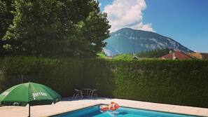 Seasonal outdoor pool, open 9:00 AM to 8:00 PM, pool umbrellas