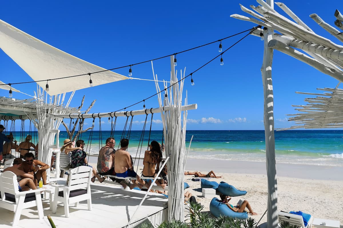 people at a beach club in tulum mexico