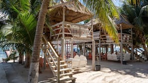 On the beach, white sand, sun loungers, beach towels