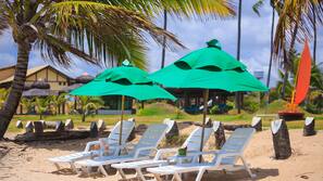 On the beach, white sand, sun-loungers, beach umbrellas