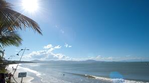 On the beach, white sand, sun-loungers, beach umbrellas