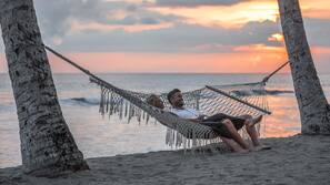 On the beach, sun-loungers, beach umbrellas, beach towels
