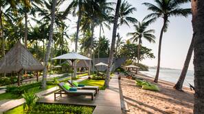 On the beach, sun-loungers, beach umbrellas, beach towels