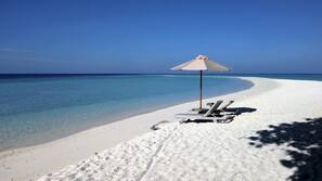 On the beach, white sand, beach towels, rowing