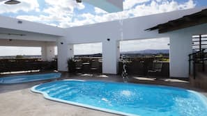 Seasonal outdoor pool, open noon to 7:00 PM, pool umbrellas