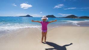 Beach nearby, white sand, beach umbrellas, beach towels