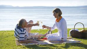 Beach nearby, white sand, beach umbrellas, beach towels