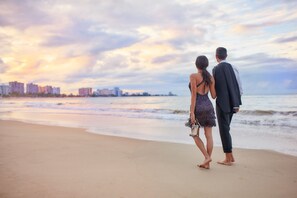 On the beach, white sand, beach cabanas, beach towels