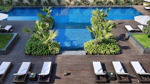 Outdoor pool, open 6:00 AM to 9:00 PM, pool umbrellas
