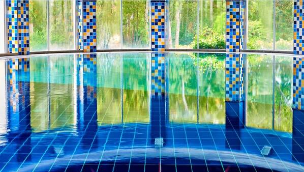 Una piscina cubierta, una piscina al aire libre