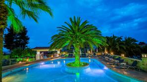 Outdoor pool, a waterfall pool, pool umbrellas, sun loungers