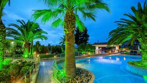 Outdoor pool, a waterfall pool, pool umbrellas, sun loungers