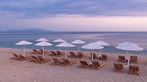 On the beach, sun loungers, beach umbrellas, beach towels