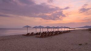 On the beach, sun loungers, beach umbrellas, beach towels