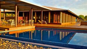 Outdoor pool, open 7 AM to 7 PM, pool loungers