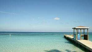 On the beach, white sand, sun loungers, beach umbrellas