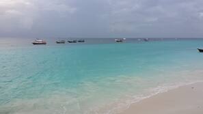 On the beach, sun-loungers, beach umbrellas, beach towels