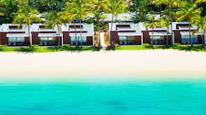 On the beach, white sand, sun loungers, beach umbrellas