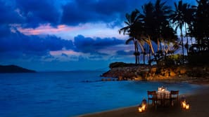On the beach, white sand, sun loungers, beach umbrellas