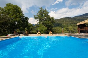 Seasonal outdoor pool, open 10:00 AM to 7:00 PM, pool umbrellas