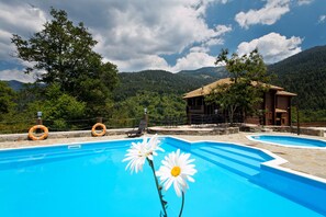Seasonal outdoor pool, open 10:00 AM to 7:00 PM, pool umbrellas