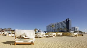 On the beach, sun-loungers, beach umbrellas, beach bar