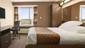 Premium bedding, desk, laptop workspace, blackout drapes