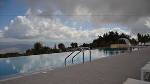 Seasonal outdoor pool, an infinity pool, pool umbrellas, sun loungers
