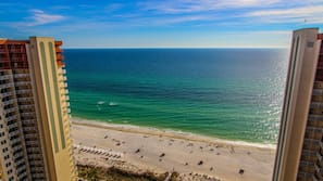 On the beach, white sand, sun loungers, beach umbrellas